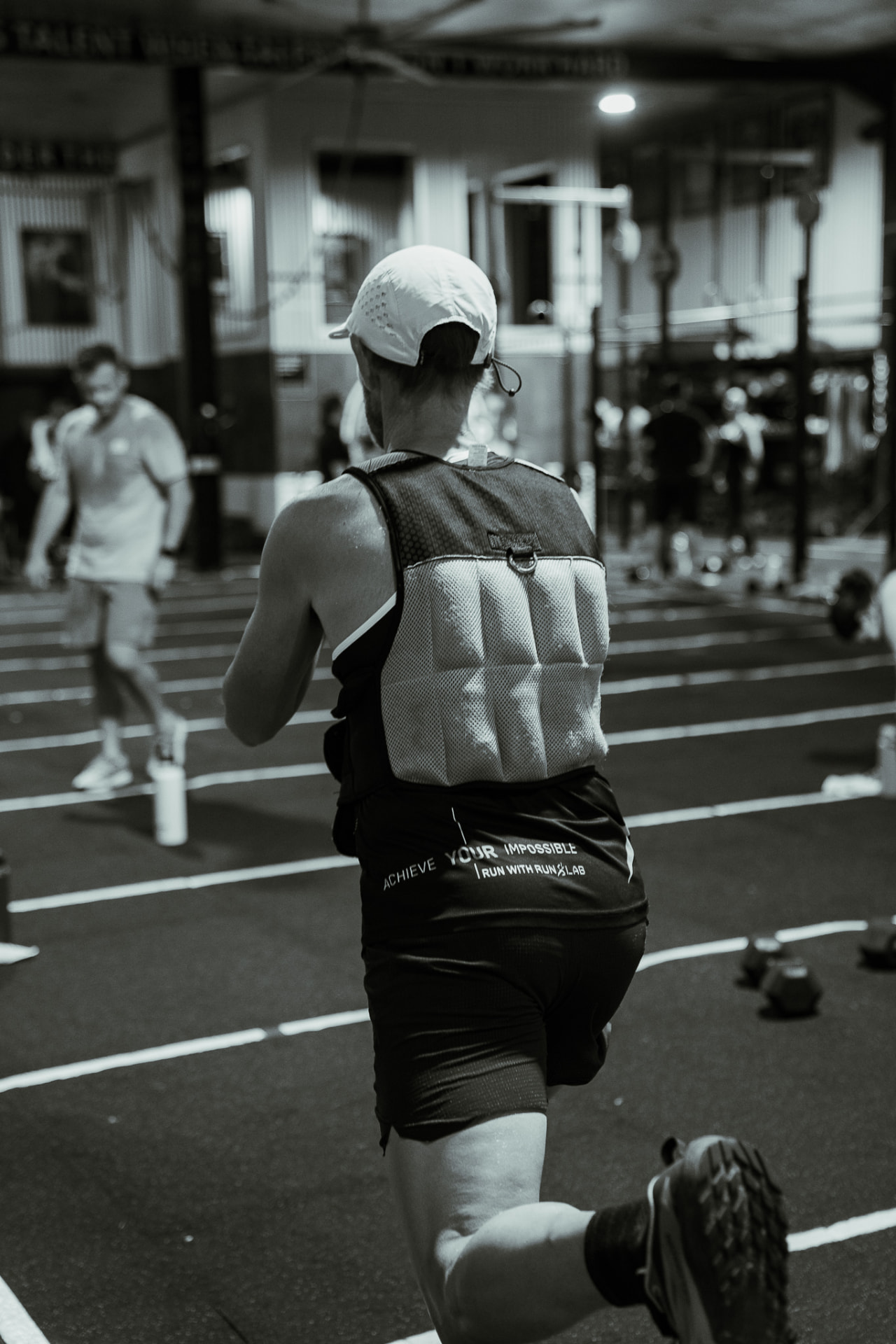 Runner training in a weight vest indoors